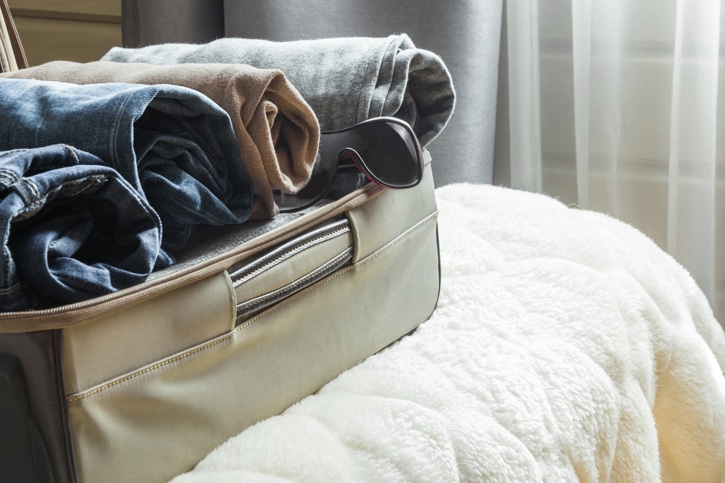 Open suitcase on bed