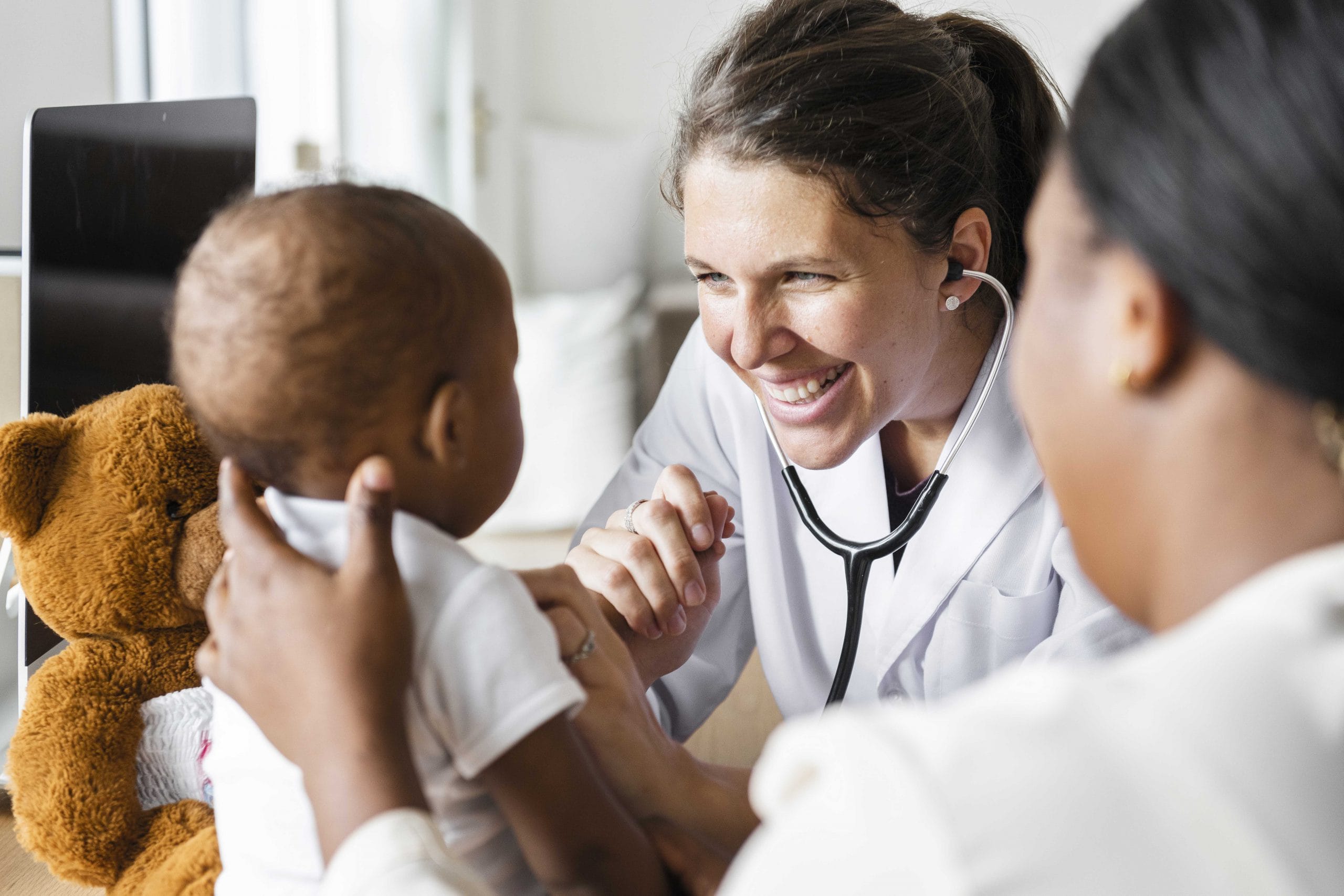Nurse smiling at a baby.